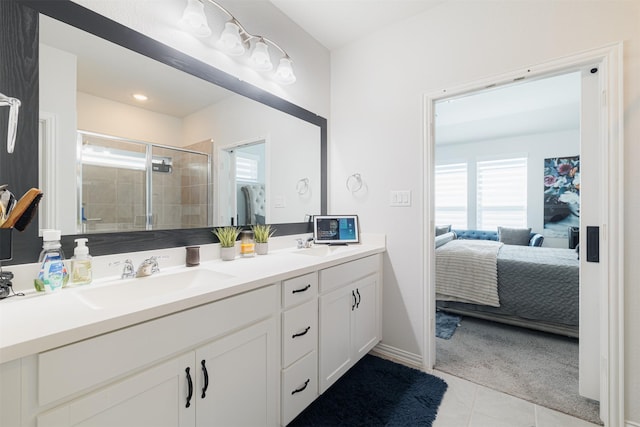 31511 Kailua Dr, Hockley, TX 77447 - ensuite bathroom with healthy amount of natural light, tile patterned floors, a shower stall, and double vanity