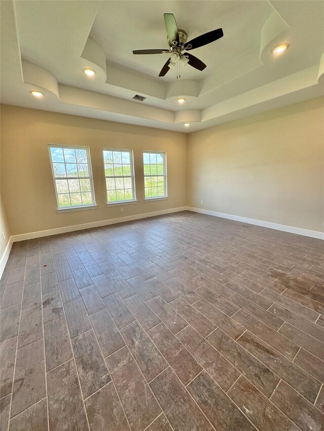 9830 Turnbow St, Houston, TX 77029 - empty room featuring baseboards, visible vents, wood finish floors, and a raised ceiling