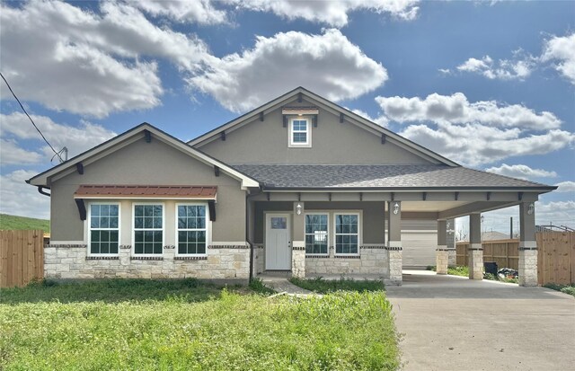 9830 Turnbow St, Houston, TX 77029 - view of front of house featuring stone siding, concrete driveway, and fence