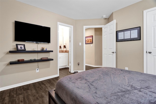 bedroom featuring dark wood finished floors, baseboards, and connected bathroom