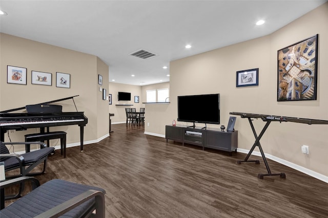 interior space with baseboards, wood finished floors, and visible vents