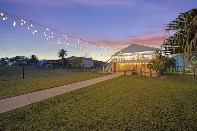 1407 John St, San Leon, TX 77539 - yard at dusk with stairs and a patio area