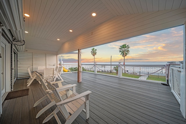 1407 John St, San Leon, TX 77539 - deck at dusk featuring a water view