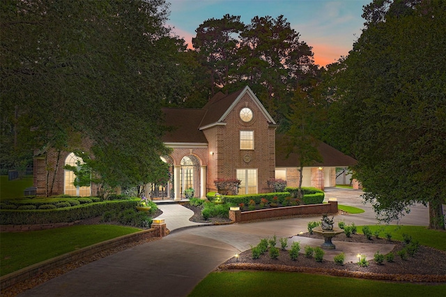 view of front facade featuring curved driveway