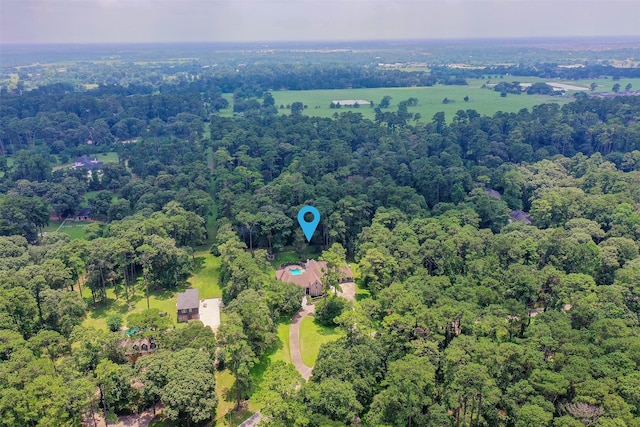 birds eye view of property featuring a wooded view