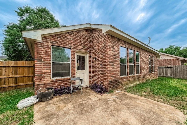 18918 Knobby Oaks Pl, Magnolia, TX 77355 - back of house featuring brick siding and a patio area
