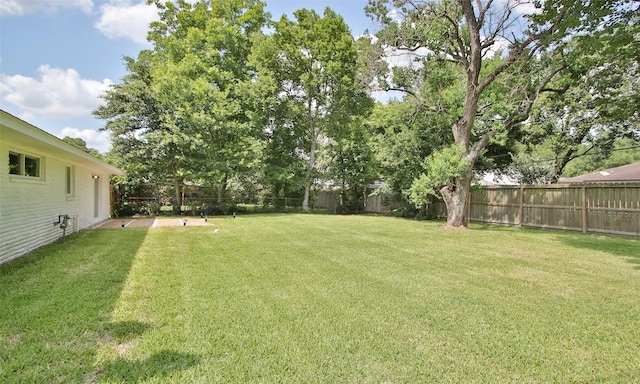 view of yard with a fenced backyard