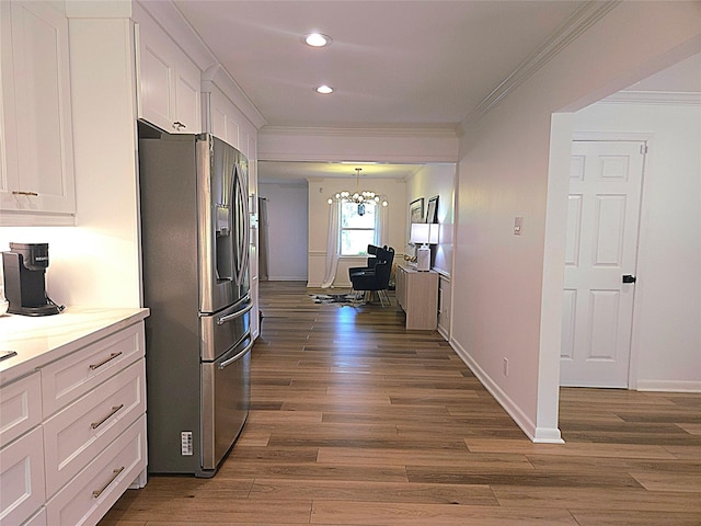 kitchen with white cabinets, stainless steel fridge, crown molding, and dark wood-type flooring