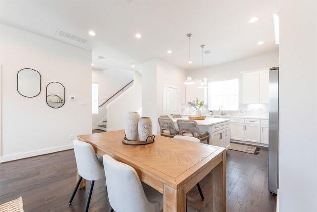 dining space with stairway, dark wood finished floors, visible vents, and recessed lighting
