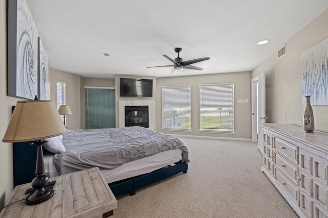 bedroom with carpet flooring, multiple windows, ceiling fan, and visible vents