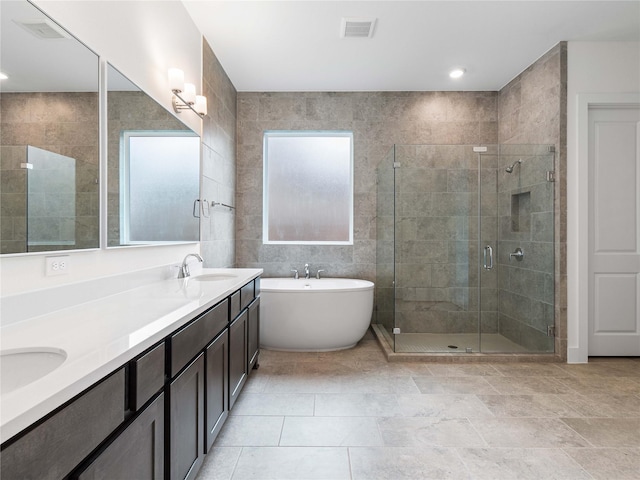 7517 Hawk Crest Dr, Fulshear, TX 77441 - bathroom featuring a freestanding tub, a stall shower, and double vanity