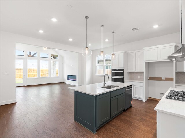 7517 Hawk Crest Dr, Fulshear, TX 77441 - kitchen with stainless steel appliances, white cabinets, a ceiling fan, tasteful backsplash, and recessed lighting