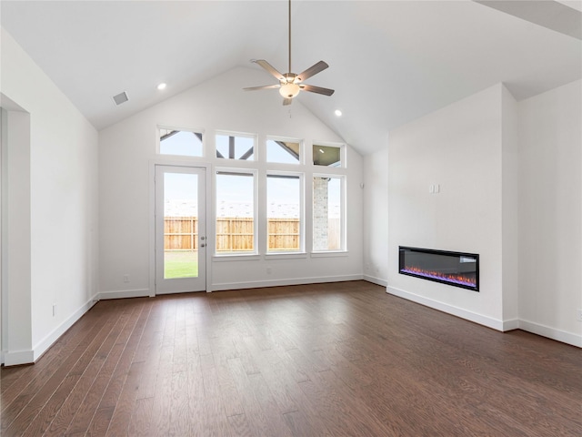 7517 Hawk Crest Dr, Fulshear, TX 77441 - unfurnished living room featuring a glass covered fireplace, ceiling fan, dark wood-style flooring, recessed lighting, and high vaulted ceiling