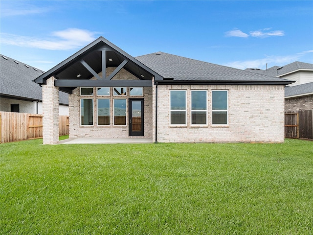 7517 Hawk Crest Dr, Fulshear, TX 77441 - back of property with a patio area, a fenced backyard, roof with shingles, and brick siding
