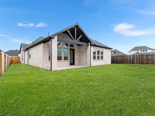 7517 Hawk Crest Dr, Fulshear, TX 77441 - back of property featuring brick siding, a fenced backyard, and a patio area