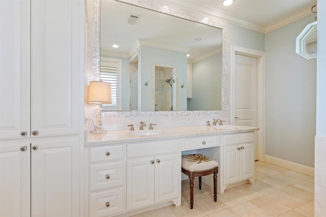 bathroom with visible vents, a shower stall, double vanity, ornamental molding, and a sink