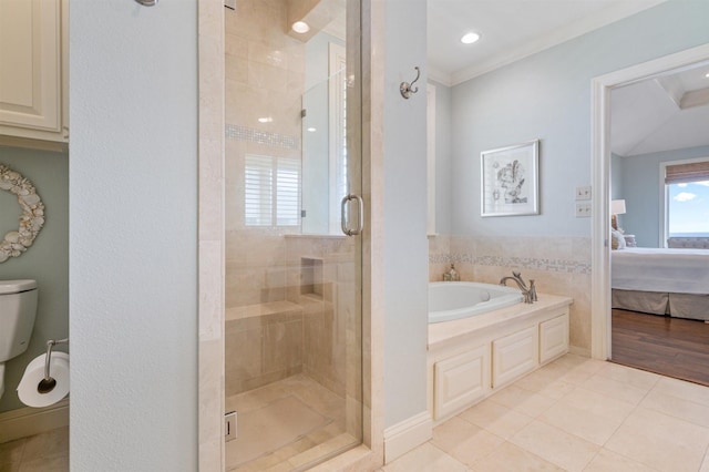 bathroom featuring a stall shower, tile patterned floors, crown molding, a garden tub, and ensuite bath