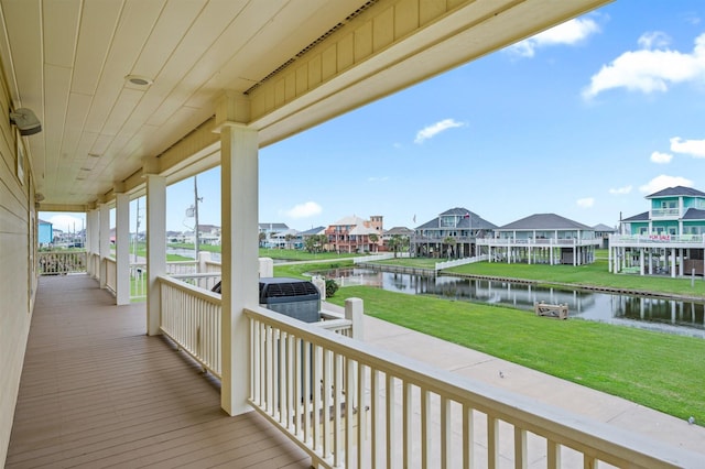 deck with a residential view, a water view, and a yard