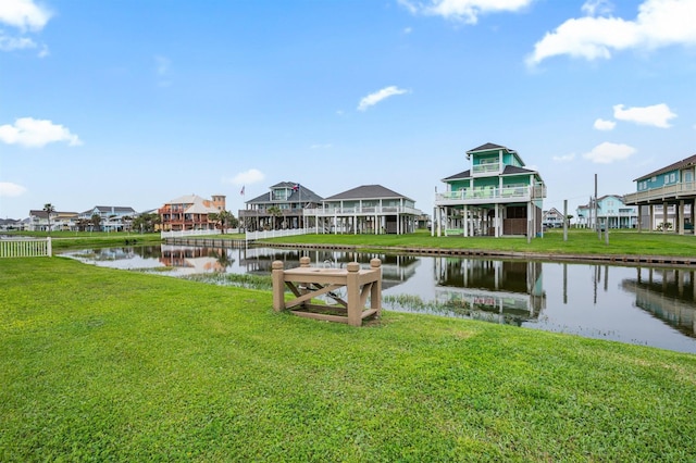 dock area with a lawn and a water view