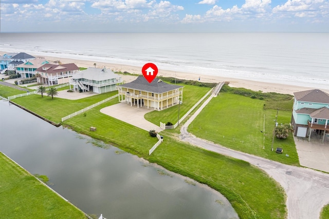 birds eye view of property featuring a water view and a beach view