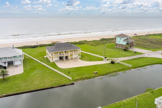 drone / aerial view featuring a water view and a beach view