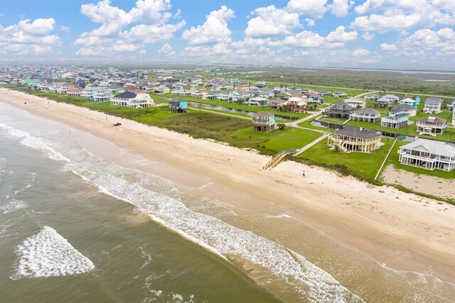 drone / aerial view with a view of the beach, a residential view, and a water view