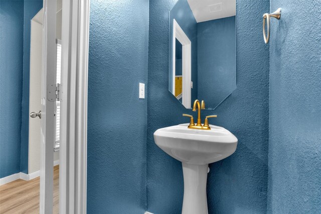 165 Camelot Place Ct, Conroe, TX 77304 - bathroom featuring wood finished floors, a textured wall, and baseboards