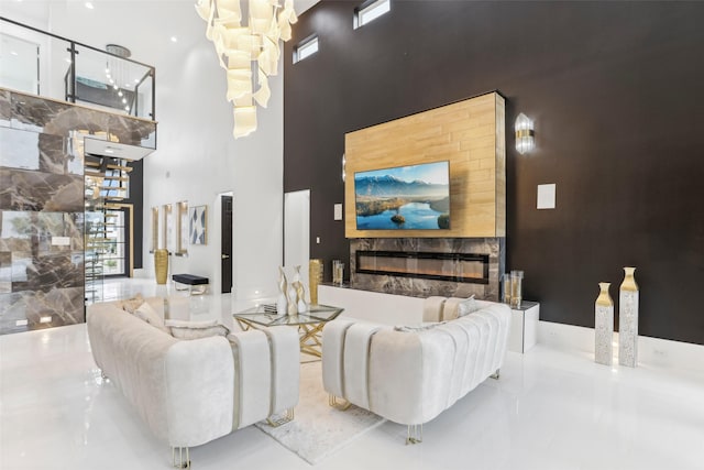 3902 Charleston St, Houston, TX 77021 - living room with a high end fireplace, a high ceiling, and a chandelier