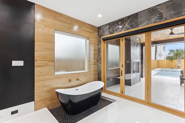 3902 Charleston St, Houston, TX 77021 - bathroom featuring wood walls and a freestanding tub
