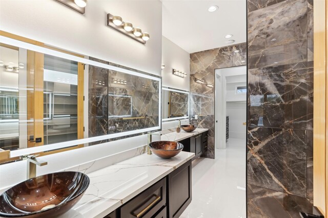 3902 Charleston St, Houston, TX 77021 - full bathroom with tile walls, double vanity, and recessed lighting