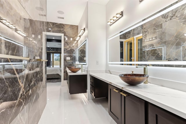 3902 Charleston St, Houston, TX 77021 - full bath featuring connected bathroom, vanity, tile walls, and tile patterned floors