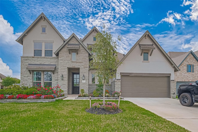 2611 Oakland Park Dr, Conroe, TX 77385 - view of front facade with stone siding, stucco siding, driveway, and a front yard
