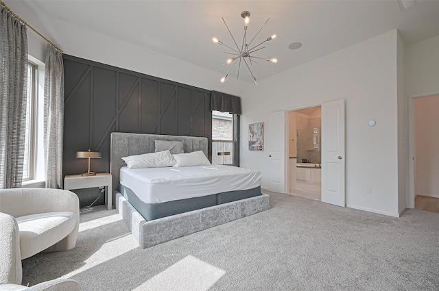2611 Oakland Park Dr, Conroe, TX 77385 - bedroom featuring light colored carpet, a chandelier, and connected bathroom