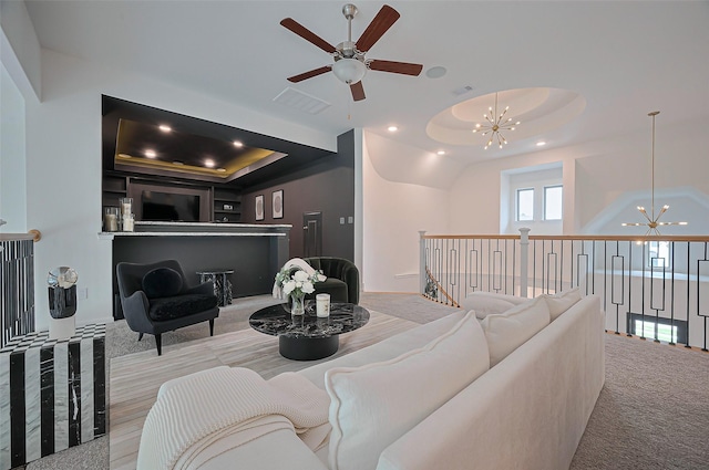 2611 Oakland Park Dr, Conroe, TX 77385 - carpeted living room with a chandelier, a tray ceiling, ceiling fan, and recessed lighting