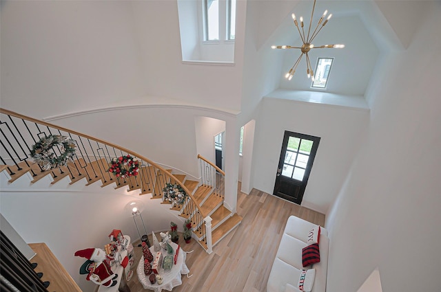 2611 Oakland Park Dr, Conroe, TX 77385 - foyer entrance featuring a high ceiling, a chandelier, wood finished floors, arched walkways, and stairway