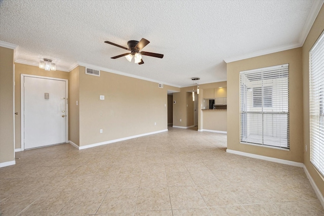 empty room with ornamental molding, baseboards, ceiling fan, and visible vents