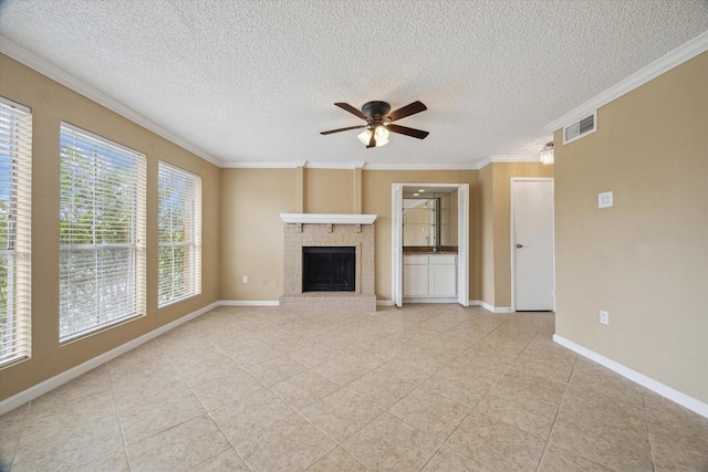 unfurnished living room with ornamental molding, baseboards, visible vents, a ceiling fan, and a fireplace