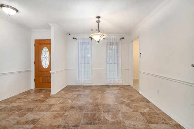 entrance foyer with stone finish flooring, ornamental molding, and baseboards