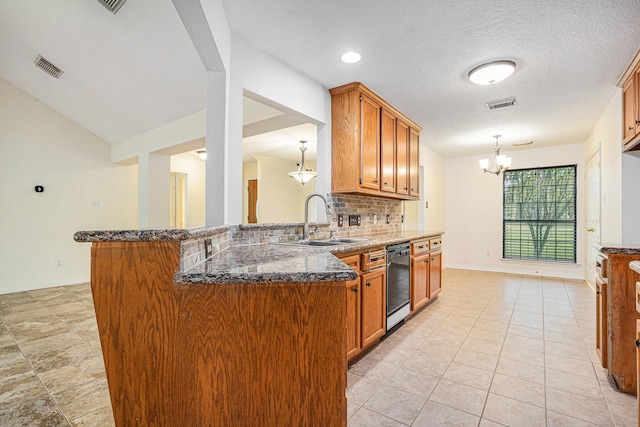 kitchen with a sink, black dishwasher, brown cabinets, and dark stone countertops