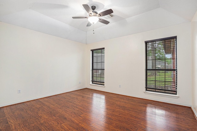 unfurnished room featuring healthy amount of natural light, lofted ceiling, and wood finished floors