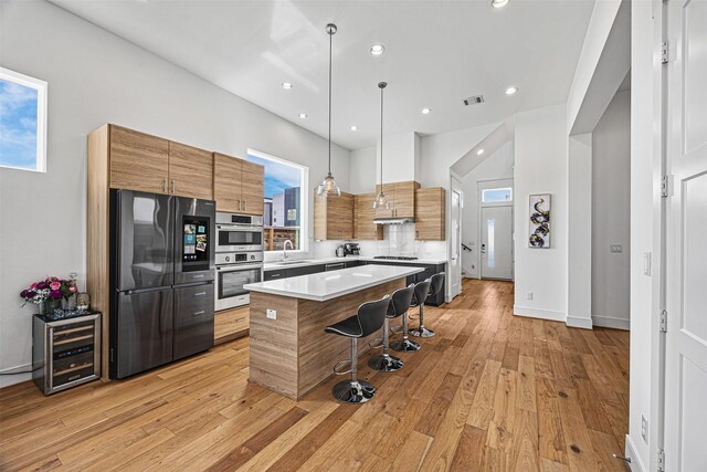 3402 Asher Landing Ln, Houston, TX 77080 - kitchen with a kitchen island, a sink, beverage cooler, stainless steel appliances, and a breakfast bar area