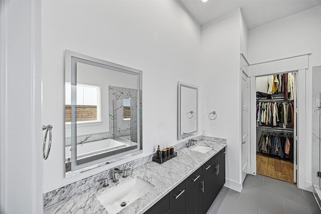 3402 Asher Landing Ln, Houston, TX 77080 - full bath featuring tile patterned flooring, double vanity, a sink, and a walk in closet