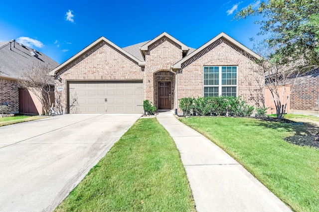 23818 Northwood Terrace Ln, Katy, TX 77493 - french country inspired facade with a front yard, brick siding, concrete driveway, and a garage