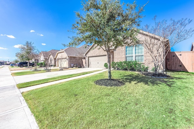 23818 Northwood Terrace Ln, Katy, TX 77493 - view of front of home with brick siding, driveway, an attached garage, and a front lawn