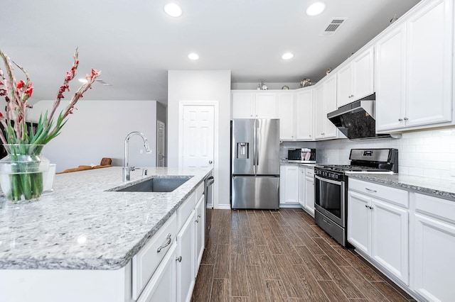 23818 Northwood Terrace Ln, Katy, TX 77493 - kitchen featuring visible vents, dark wood finished floors, tasteful backsplash, appliances with stainless steel finishes, and a sink