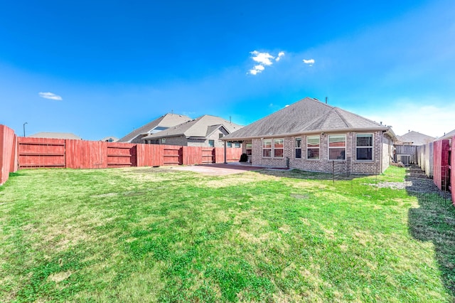 23818 Northwood Terrace Ln, Katy, TX 77493 - rear view of house featuring a fenced backyard, a patio, brick siding, and a yard
