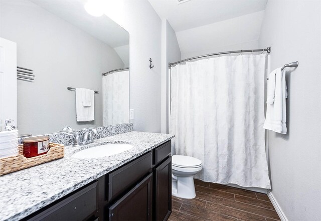 23818 Northwood Terrace Ln, Katy, TX 77493 - full bathroom featuring wood finish floors, vanity, toilet, and baseboards