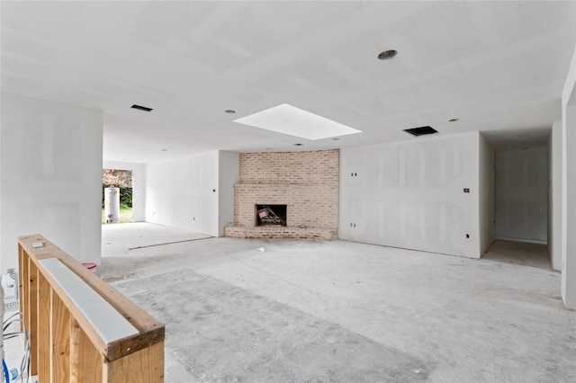 6206 Yarwell Dr, Houston, TX 77096 - unfurnished living room featuring a skylight, a brick fireplace, and water heater
