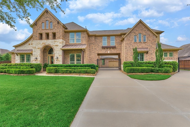 21610 Harbor Water Dr, Cypress, TX 77433 - view of front of property featuring a gate, brick siding, a standing seam roof, and a shingled roof