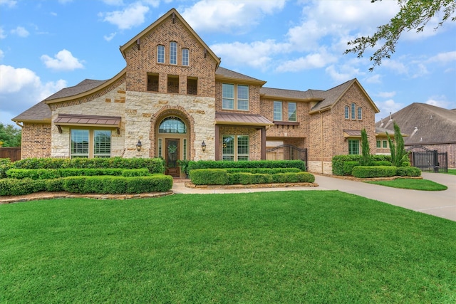 21610 Harbor Water Dr, Cypress, TX 77433 - view of front of property with brick siding, a standing seam roof, and stone siding